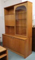 A 20th century teak veneered wall unit with fall front compartment alongside glazed door on two door