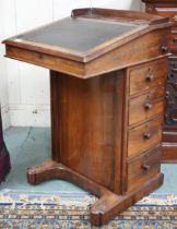 A Victorian rosewood Davenport writing desk with hinged writing slope top over four drawers to right