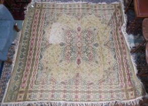 A yellow ground Tabriz style throw with multicoloured central medallion on ground decorated with