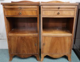 A pair of 20th century serpentine front bedside cabinets with slides over single drawers and