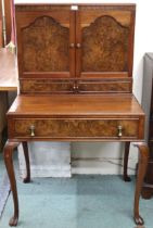 An early 20th century mahogany and walnut veneered dressing table with pair of panel doors with