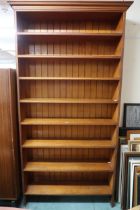 A large 20th century open bookcase with moulded cornice over eight open shelves, 238cm high x