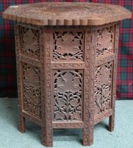 A 20th century carved Anglo-Indian style octagonal table, 55cm high x 53cm wide x 53cm deep