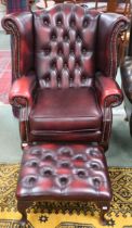 A 20th century oxblood leather button back upholstered Chesterfield style wingback armchair, 106cm