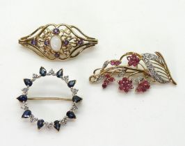 A 9ct ruby and diamond flower brooch, length 4cm, a sapphire and diamond brooch and a further opal