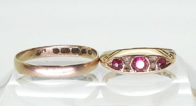 An 18ct gold Victorian wedding ring, hallmarked Birmingham 1873, size S, and a 15ct gold red gem