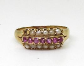 A 15c ruby and split pearl ring, size O1/2, weight 2.7gms Condition Report:One pearl missing.