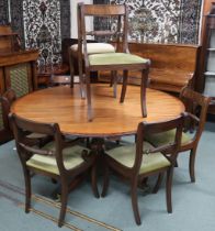 A 20th century mahogany extending dining table and eight chairs, dining table with circular top with