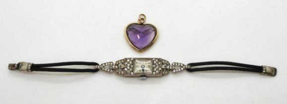 A yellow metal heart shaped amethyst pendant, with the dimensions 2cm x 2.2cm, and a silver cased