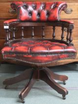 A 20th century oxblood leather button back upholstered captains style swivel desk chair, 80cm high x