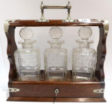 A three bottle decanter in wooden stand with silver plated mounts Condition Report:Available upon