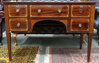 A Victorian mahogany desk with long central drawer flanked by two short drawers either side on