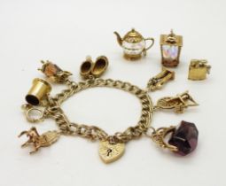 A 9ct gold double curb link charm bracelet with heart shaped clasp and eight attached charms with