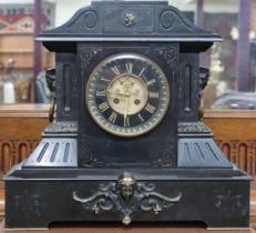 A lot comprising an early 20th century black slate mantel clock with skeletonised dial bearing