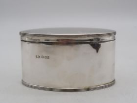 A George V silver biscuit box, by Robert Stewart, London 1918, of oval form, 424gms Condition