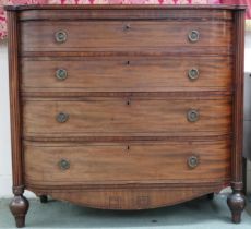 A 19th century mahogany chest with four long drawers flanked by reeded columns on turned supports