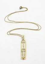 An Egyptian gold hieroglyph pendant and box chain (clasp not gold) weight together 6.8gms