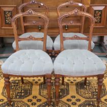 A set of four Victorian Walnut framed parlour chairs with carved back rests over button