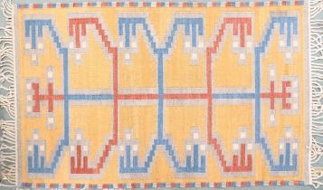 A yellow ground Kilim tribal rug with blue and red geometric patterned ground, 154cm long x 96cm