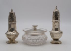 A silver caster, London, of faceted form, another similar, Chester, a silver cut glass vanity jar,