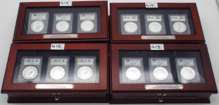 Australian silver commemorative coin sets in wood display cases, each containing three silver coins.