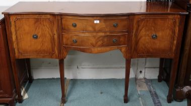 A 20th century mahogany serpentine front sideboard with two central drawers flanked by cabinet doors