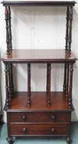 A Victorian mahogany what-not with two open shelves separated buy turned supports over two drawers