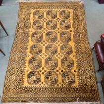 A yellow ground Bokhara rug with lozenge pattern ground and geometric border, 314cm long x 216cm