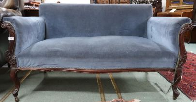 A Victorian blue velour upholstered sofa on carved cabriole supports terminating in ceramic casters,