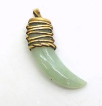 A 9ct gold QVC designed green hardstone, tooth pendant, weight 8.6gms Condition Report:Available