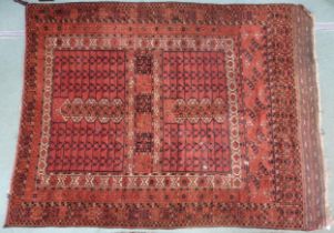 A red four panelled ground Hatchli rug with multicoloured geometric borders, 220cm long x 169cm
