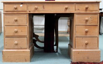 A 20th century pine pedestal desk with three drawer top on pair of three drawer pedestals with