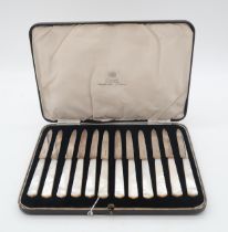 A cased set of silver mother of pearl fruit knives, by C W Fletcher & Son, Sheffield 1933  Condition