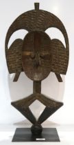An African wooden mask on stand with brass detailing Condition Report:Available upon request