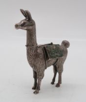 A Peruvian silver model of a llama, with inset stones, marked 925 and peru to underside, 10.2cm high
