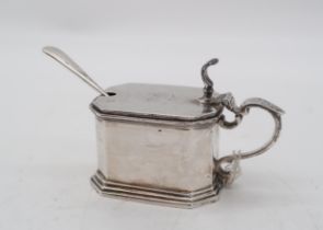 A silver mustard pot, by Mappin & Webb, London, with a blue glass insert, of faceted form, 159gms,