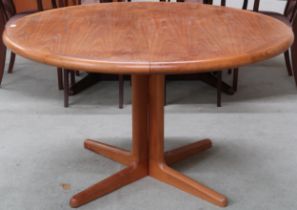 A mid 20th century Scandinavian style teak circular topped extending dining table with two