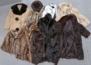 A collection of fur coats and jackets, including a white and blonde example, a fur trimmed suede