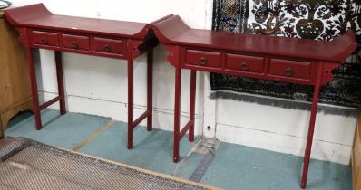 A pair of 20th century red painted Oriental style altar tables each with scrolled top over three