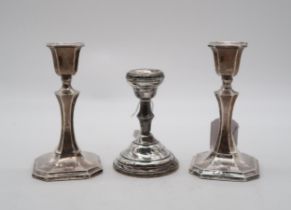 A pair of silver candlesticks, by James & William Deakin, Chester, of faceted form, and another