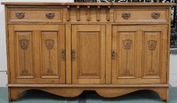 A late Victorian blonde oak Arts & Crafts sideboard with shaped rectangular top over two drawers