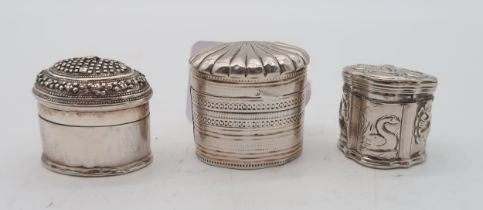 Three Dutch silver spice boxes, one with decoration of a monkey carrying grapes, another with a