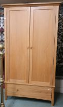 A contemporary beech wardrobe with pair of doors on single drawer base, 197cm high x 113cm wide x