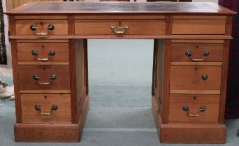 A late Victorian pedestal writing desk with embossed skiver top over three drawers on pair of