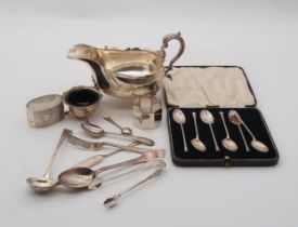 A cased set of six silver spoons by George Howson Sheffield, a silver sauce boat by Thomas
