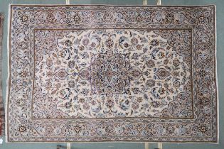 A cream ground Meshed rug with multicolour flower head central medallion, matching spandrels and
