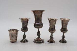 A collection of silver Kuddish cups, including one bby J Zeving, London, three by Rozenzweig,