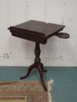 A 19th century mahogany freestanding writing slope with hinged top over pen drawer and candle stands