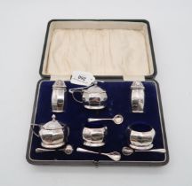 A cased six piece silver cruet set, by GM & Co, Birmingham 1918, of faceted form, 168gms Condition