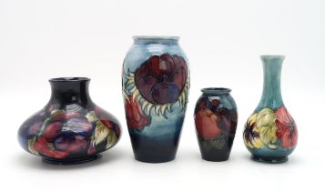 A COLLECTION OF MOORCROFT POTTERY including a squat Pansy vase on dark blue ground, 12cm high, a